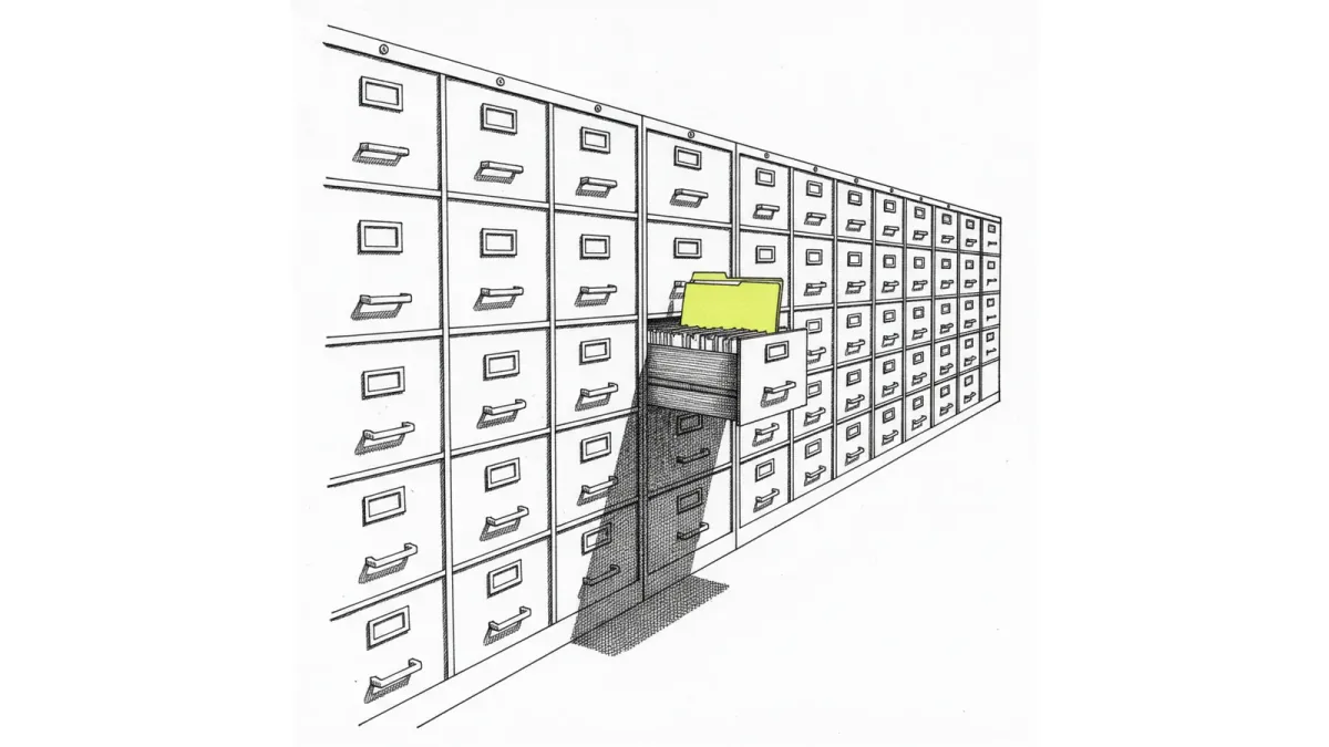 A beam of light finding one document in a dim archive